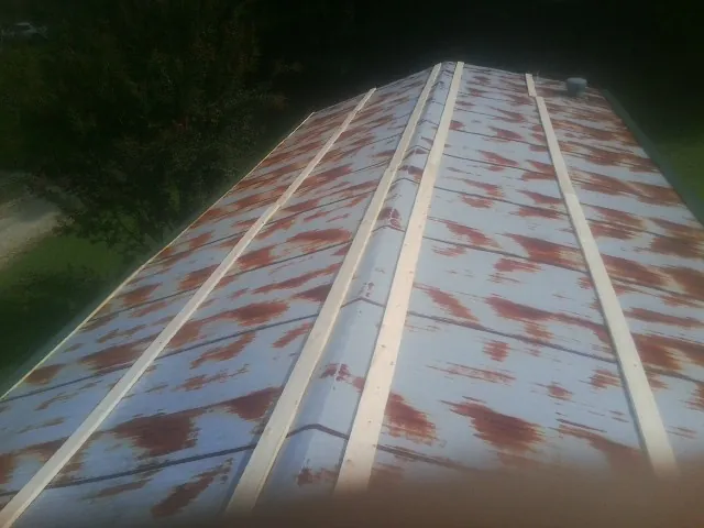 Rusted metal roof panels with new wood purlins before replacement — Storm Damage Roof Repair in Gordon by Roofing Brothers
